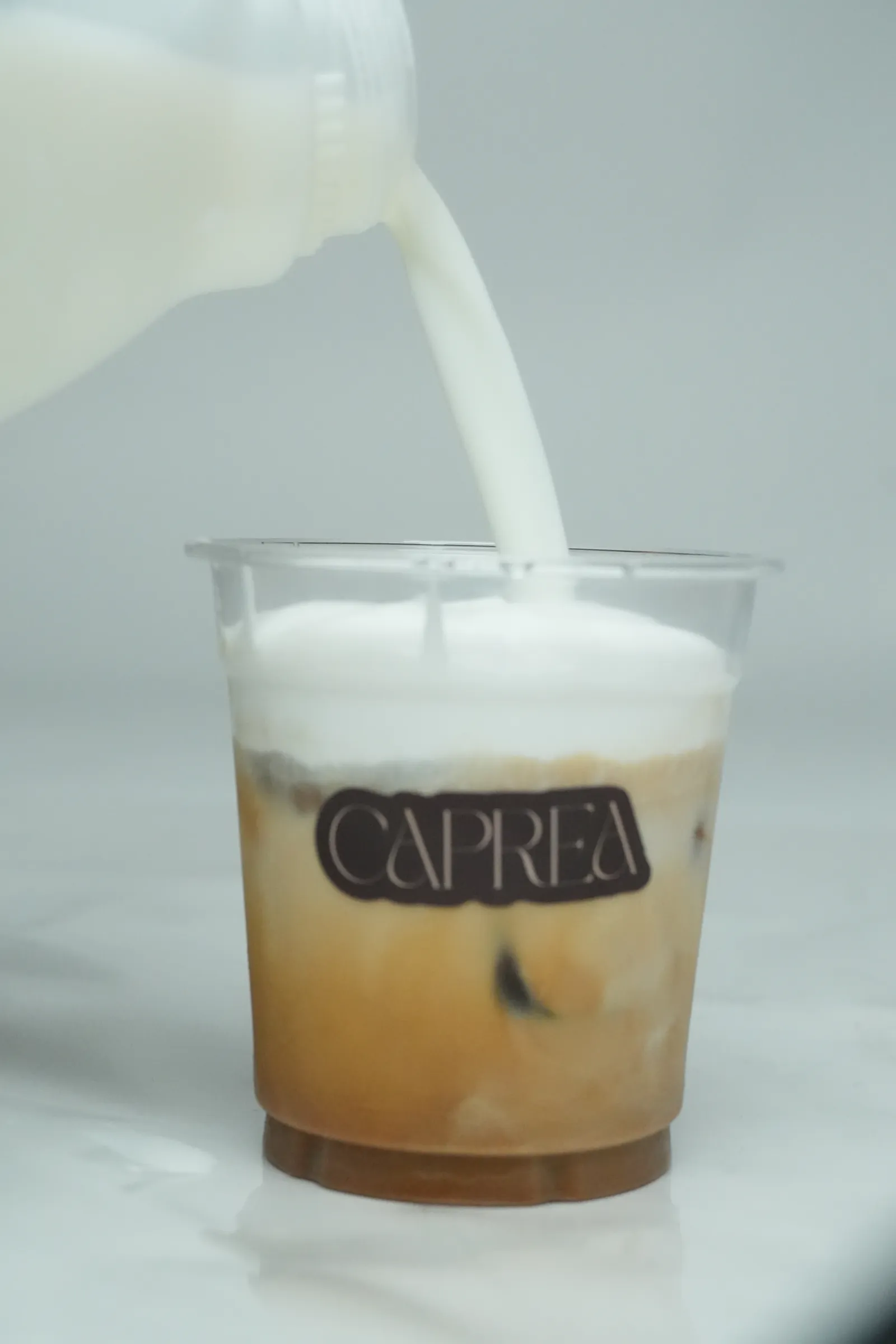 Milk poured into an iced latte