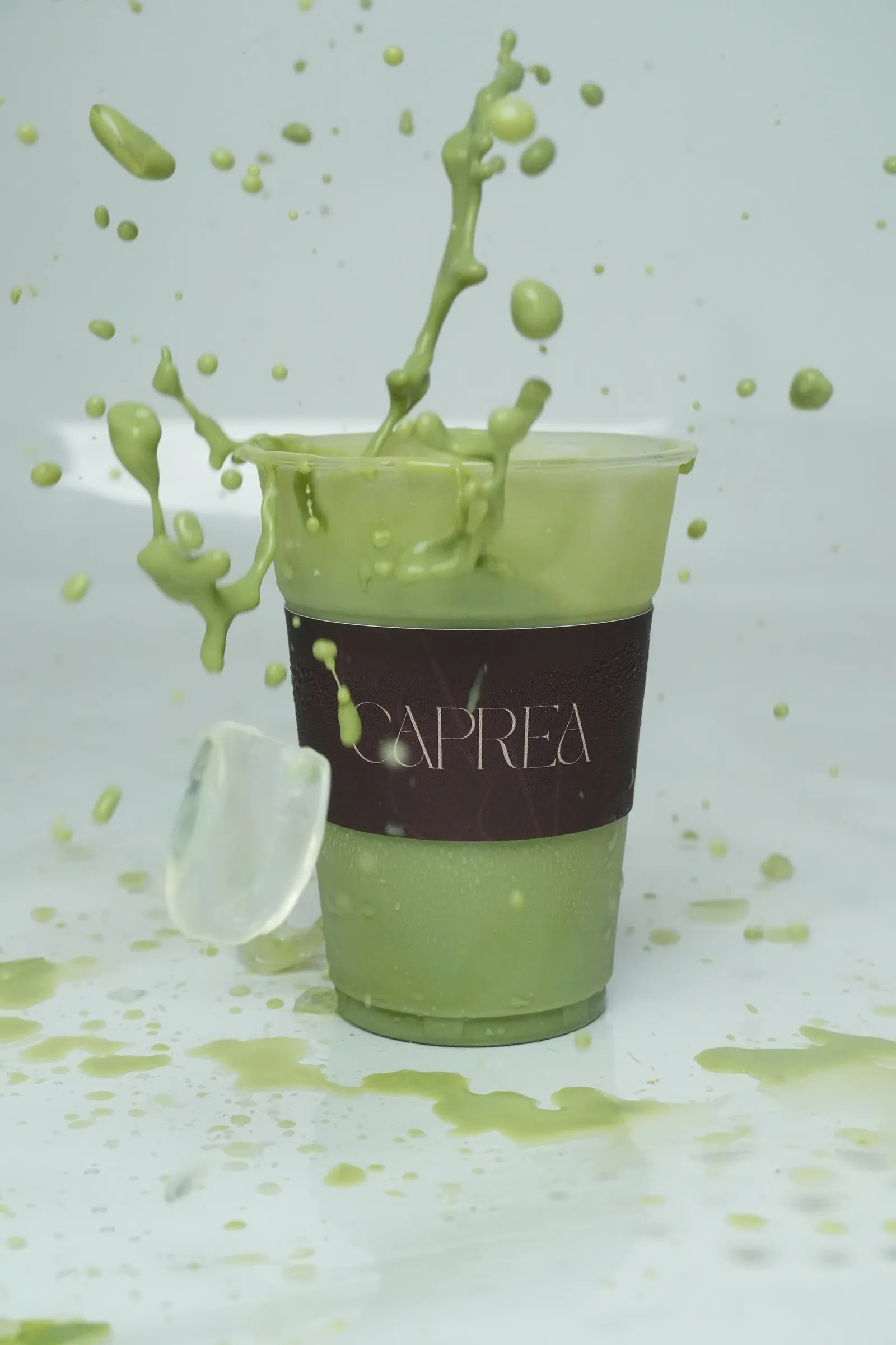 Matcha splashing from a Caprea cup
